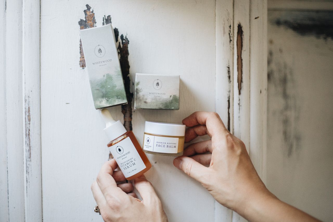 Flat lay of artisanal skincare products on a rustic surface, showcasing natural beauty essentials.